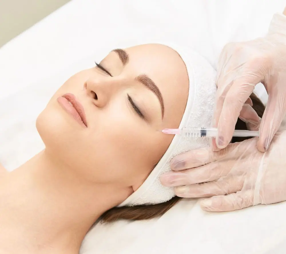 A woman getting an injection in her face.